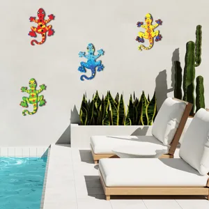 Metal gecko wall art detail showing colorful lizard sculptures hanging on outdoor pool wall.