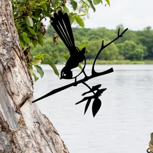 Detailed shot of black metal bird silhouette tree stake, perfect outdoor garden decoration.