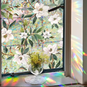 Detail shot of rainbow prism glass window film featuring watercolor magnolia flower pattern and light refraction.