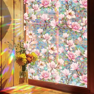 Close-up view of vibrant rainbow window film featuring beautiful pink magnolia floral patterns.
