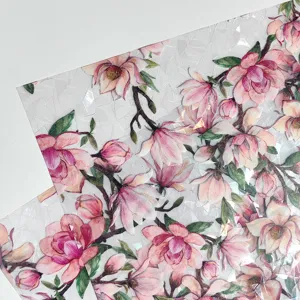 Detail view of static cling glass window film featuring pink magnolia flower and prism rainbow texture.