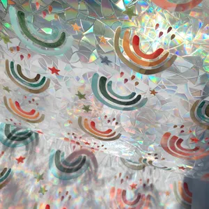 Holographic window film detail showcasing vibrant rainbow and star prism patterns with light reflection.