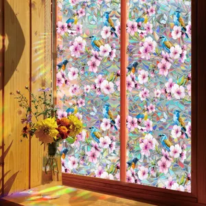 Colorful iridescent window film with bird and cherry blossom pattern for home decor.