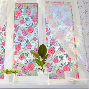 Close up view of floral window film showing colorful prism light rainbow effect on glass.