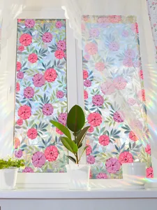 Detailed view of colorful floral window film showing beautiful prism rainbow light effects on glass.