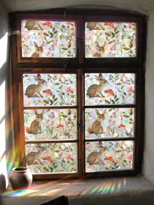Detailed view of colorful window film showcasing vibrant rainbow prisms and cute bunny pattern.