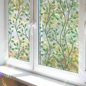 Detail shot of decorative window film with green leaf vine pattern and rainbow prism effect.