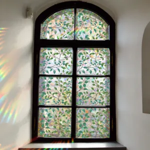 Colorful static window film with green leaf pattern, iridescent rainbow glass sticker for home.