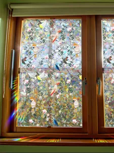 Rainbow window film prismatic colorful static glass sticker with birds and flowers design.