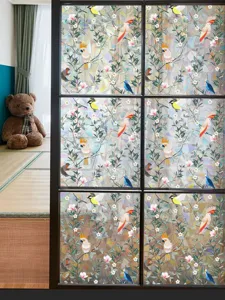 Colorful stained glass window film with vibrant bird and floral patterns for home privacy and decor.