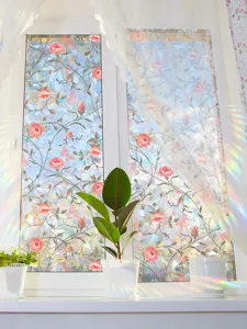 Decorative rainbow window film with floral rose pattern, stunning prism sun catcher effect for home.