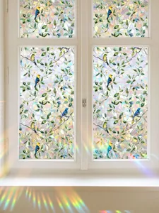 Detailed view of rainbow window film with stained glass bird pattern and prism light effect.