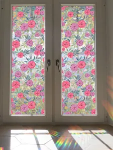 Detailed view of colorful floral static window film casting stunning rainbow light in room.