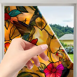 Close-up detail of colorful stained glass window film peeling off, floral sticker design.