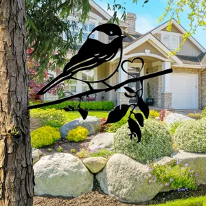 Metal bird tree silhouette decor detail, black iron garden art outdoor backyard ornament.
