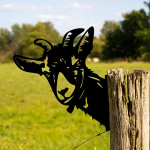 Black metal goat garden stake detail view showing cute animal silhouette on wooden fence post.