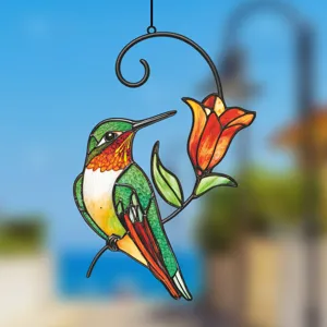 Stained glass hummingbird detail, metal frame hanging window decoration craft close-up.