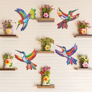Colorful metal hummingbird wall decor detail scene showing bright hand-painted garden art.