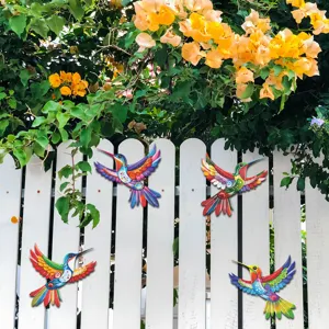 Colorful metal hummingbird wall art detail, vibrant outdoor garden fence hanging decor scene.
