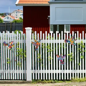 Colorful metal hummingbird wall art detail, perfect for outdoor garden fence and home decor.
