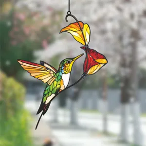 Detailed view of stained glass hummingbird hanging ornament with vibrant colors for window decor.