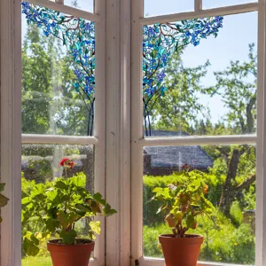 Detailed close-up view of blue floral stained glass window film showing decorative effect.