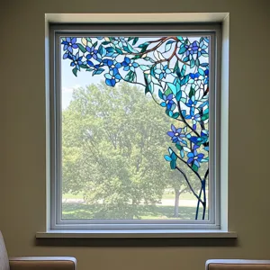 Decorative static cling window film featuring blue floral branch design for privacy and style.