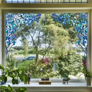 Decorative stained glass window film with blue floral pattern for home privacy and window decor.