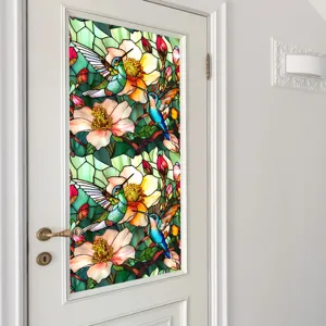 Stained glass window film featuring vibrant hummingbird and flower pattern on a glass door.