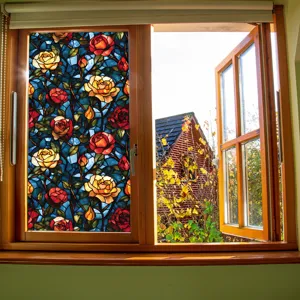 Detailed view of stained glass window film featuring colorful rose floral pattern on glass.