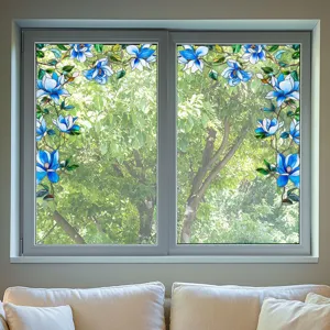 Detail shot of stained glass window film featuring blue floral patterns for privacy and decor.