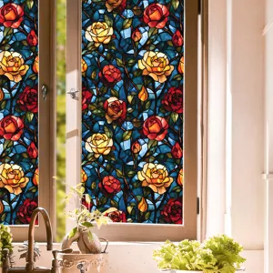 Stained glass window film detail showing vibrant rose floral pattern and colorful light effect.