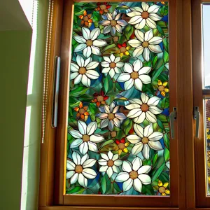 Stained glass window film detail showing vibrant white floral daisy patterns on wooden frame.