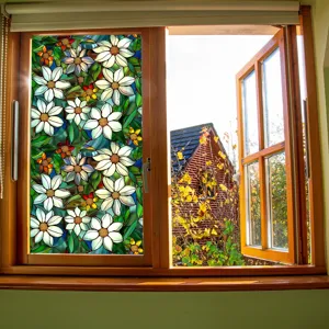 Stained glass window film detail showing white floral pattern on glass panel in wooden window.