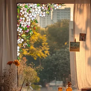 Close-up detail of stained glass window film featuring elegant floral vine design for home decor.