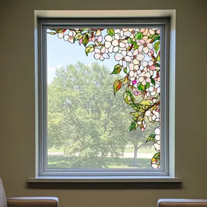 Detailed view of decorative stained glass window film featuring elegant white floral patterns.