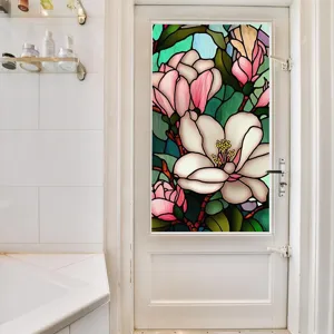 Detailed scene of stained glass floral window film applied on a white glass door in bathroom.