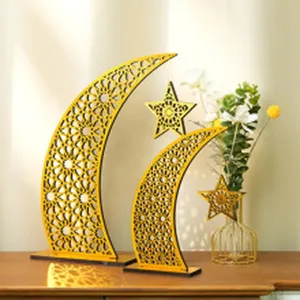 Detailed view of gold acrylic moon and star desktop decor, elegant hollow Islamic geometric design.