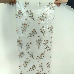 Static window film detail showing holographic rainbow daisy floral pattern and colorful texture.