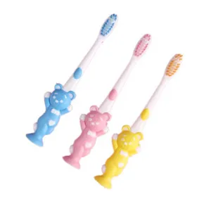Cute cartoon bear kids toothbrush with soft bristles and suction base for daily oral care.