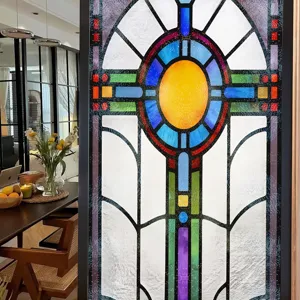 Close-up detail of colorful geometric stained glass window film in home interior decor.