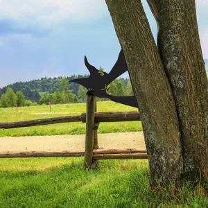 Outdoor metal tree silhouette decor, peeking witch design, detailed garden art accessory.