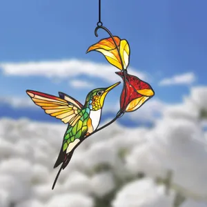 Close-up detail view of colorful stained glass hummingbird hanging decoration for window and wall