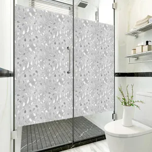 Gedetailleerd uitzicht op matte PVC statische glasraamfolie met leuk retro bladpatroon.
