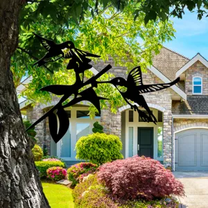 Metal hummingbird tree stake detail, perfect for outdoor garden and backyard decoration.