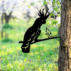 Metal cockatoo garden stake detail shot, black silhouette decor for outdoor trees and yards.