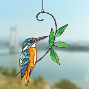 Detailed view of metal kingfisher hanging suncatcher with green leaves for window or wall decor.