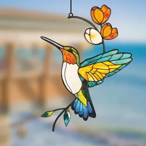 Detailed close-up view of metal hummingbird window hanging, vibrant stained glass style art decor.