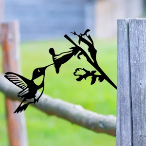 Metal hummingbird garden stake detail, black iron silhouette fence decor for outdoor yard.