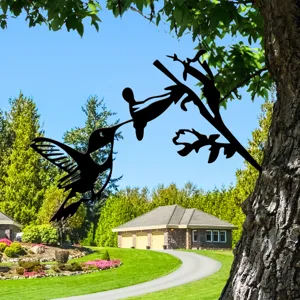 Metal hummingbird silhouette tree stake, artistic garden decor detail in outdoor yard.